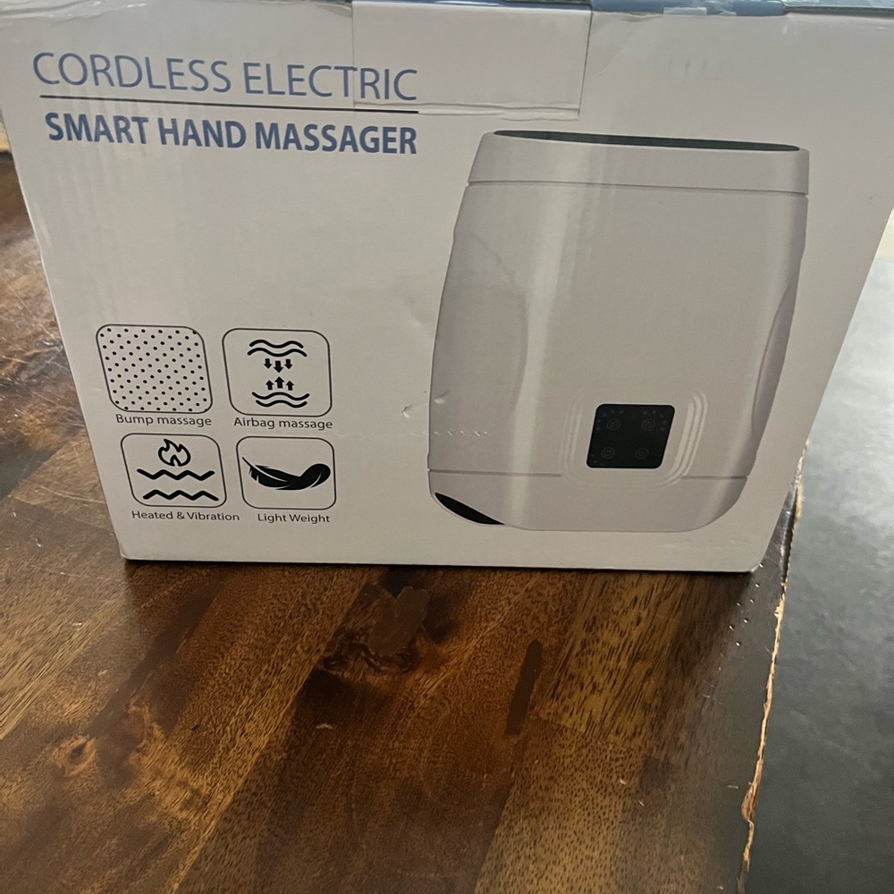 New in box Hand massager includes charging cord